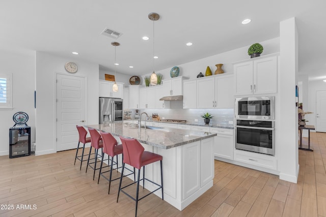 5637 S Parrish, Mesa, AZ 85212 - kitchen featuring appliances with stainless steel finishes, light wood-style floors, white cabinetry, and recessed lighting