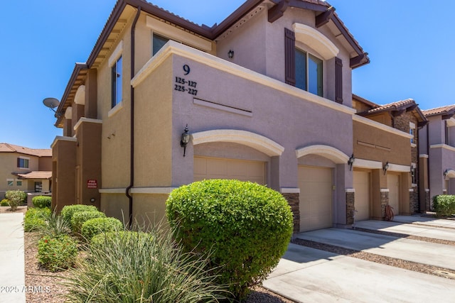 7726 E Baseline Rd Unit 125, Mesa, AZ 85209 - view of building exterior with a garage and driveway
