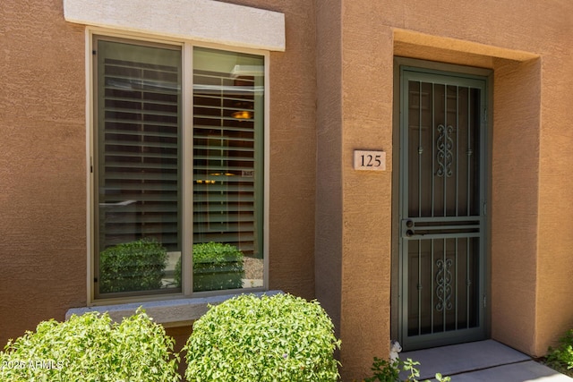 7726 E Baseline Rd Unit 125, Mesa, AZ 85209 - doorway to property with stucco siding