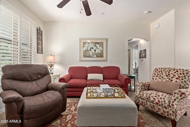 7726 E Baseline Rd Unit 125, Mesa, AZ 85209 - living room featuring arched walkways, a ceiling fan, and carpet flooring