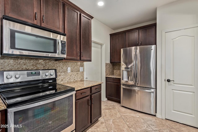 7726 E Baseline Rd Unit 125, Mesa, AZ 85209 - kitchen featuring appliances with stainless steel finishes, light stone counters, tasteful backsplash, dark brown cabinets, and light tile patterned floors