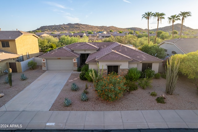 view of front of property with a mountain view and a garage