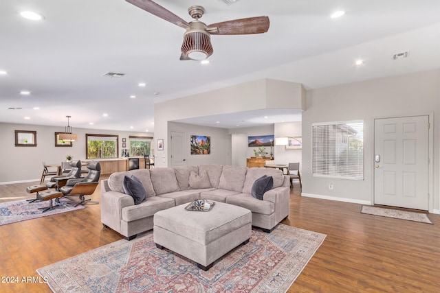 living room with dark wood-type flooring and ceiling fan