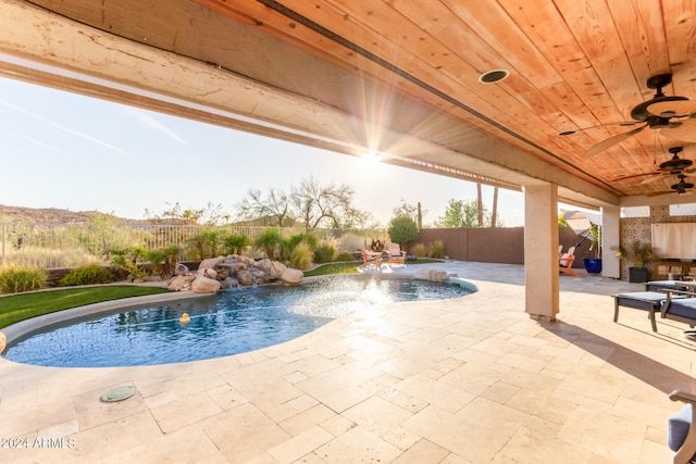 view of swimming pool featuring a patio area, ceiling fan, and pool water feature