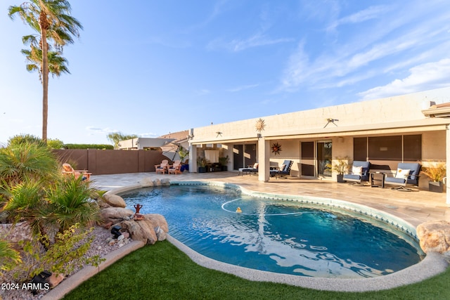 view of pool featuring an outdoor living space and a patio area