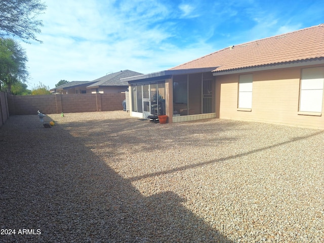 rear view of house featuring a sunroom