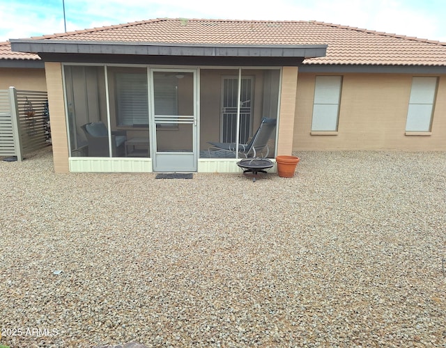 rear view of house featuring a sunroom