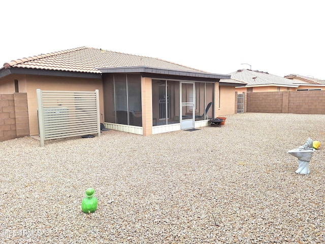 back of house featuring a sunroom