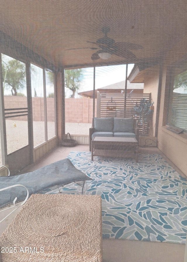 sunroom / solarium featuring ceiling fan