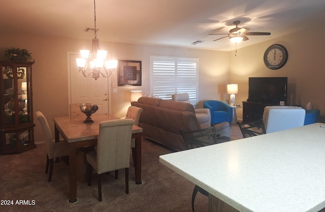 carpeted dining room featuring ceiling fan with notable chandelier