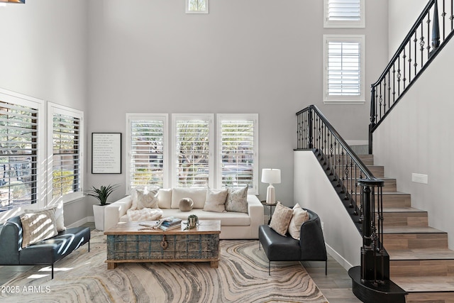 living room featuring hardwood / wood-style flooring and a high ceiling