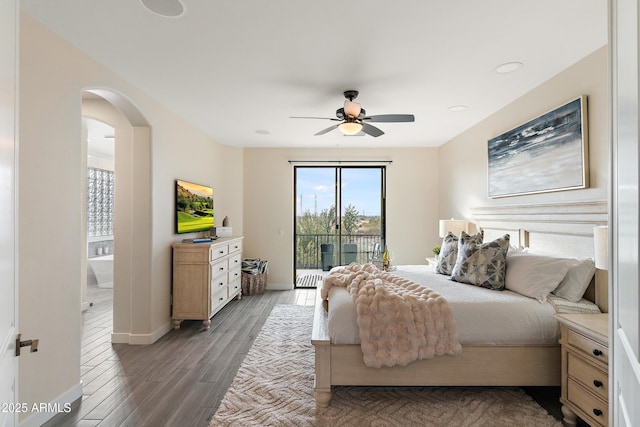 bedroom featuring access to exterior, dark hardwood / wood-style floors, and ceiling fan