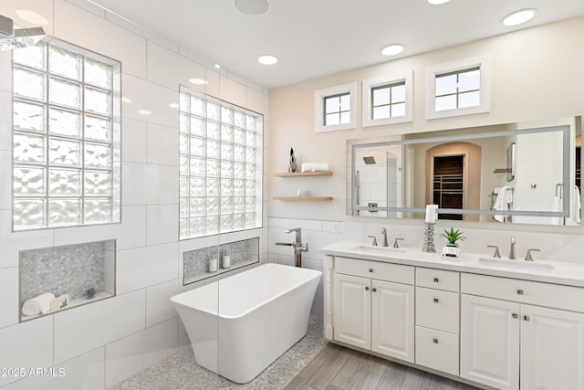 bathroom featuring a bathing tub, tile walls, and vanity