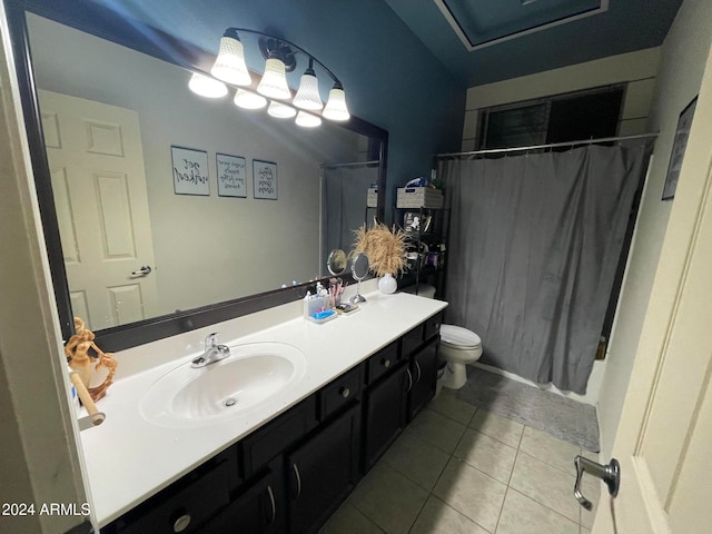 bathroom featuring toilet, vanity, tile patterned floors, and curtained shower