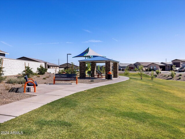 view of property's community with a lawn and a gazebo