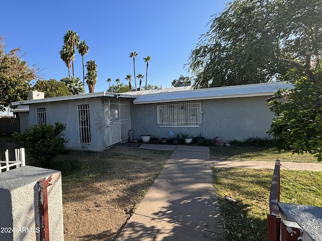 ranch-style house with a front lawn