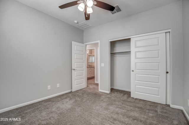 unfurnished bedroom with ceiling fan, a closet, and carpet flooring