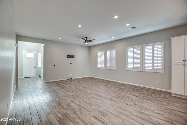 unfurnished room with ceiling fan and light wood-type flooring