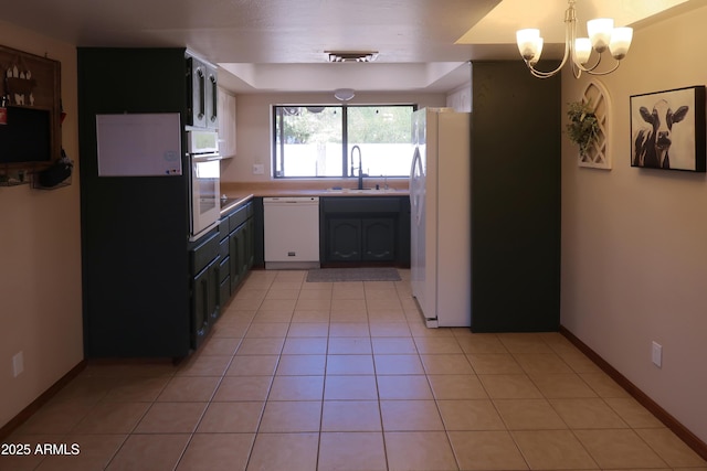 kitchen featuring light tile patterned floors, a notable chandelier, white appliances, a sink, and light countertops