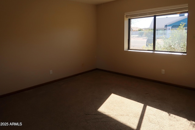 carpeted empty room with baseboards