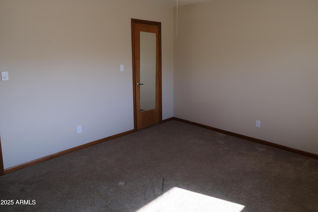 carpeted empty room with baseboards