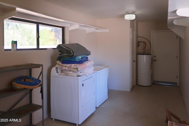 laundry room featuring laundry area, water heater, separate washer and dryer, and light colored carpet