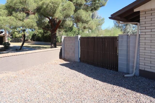 view of gate with fence