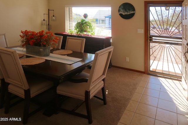 dining area with baseboards and light tile patterned floors