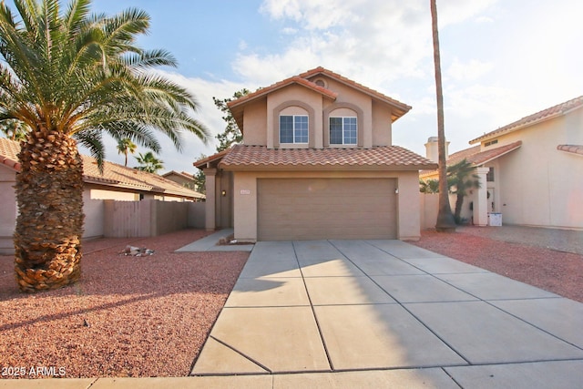 mediterranean / spanish-style home with a garage