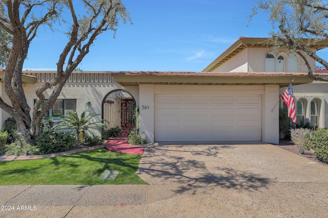 361 E Palm Ln, Phoenix, AZ 85004 - view of front of home featuring stucco siding, driveway, and an attached garage