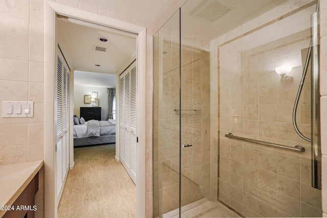 361 E Palm Ln, Phoenix, AZ 85004 - full bathroom with ensuite bathroom, a stall shower, vanity, and tile walls