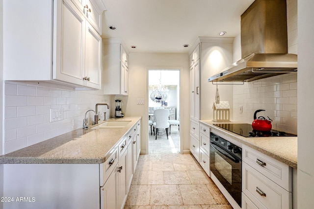 361 E Palm Ln, Phoenix, AZ 85004 - kitchen featuring black appliances, ventilation hood, backsplash, white cabinets, and recessed lighting