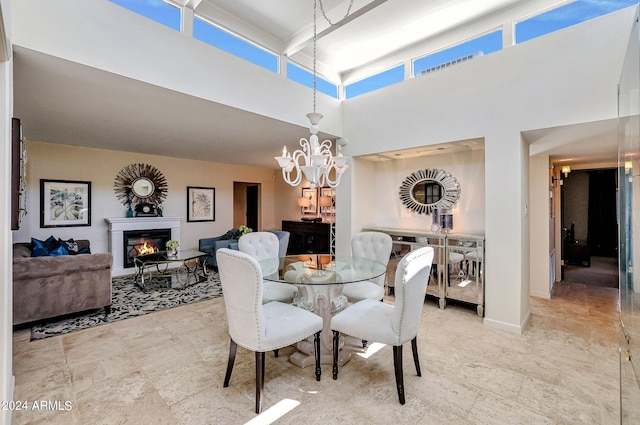 361 E Palm Ln, Phoenix, AZ 85004 - dining room featuring a glass covered fireplace, a high ceiling, and a chandelier