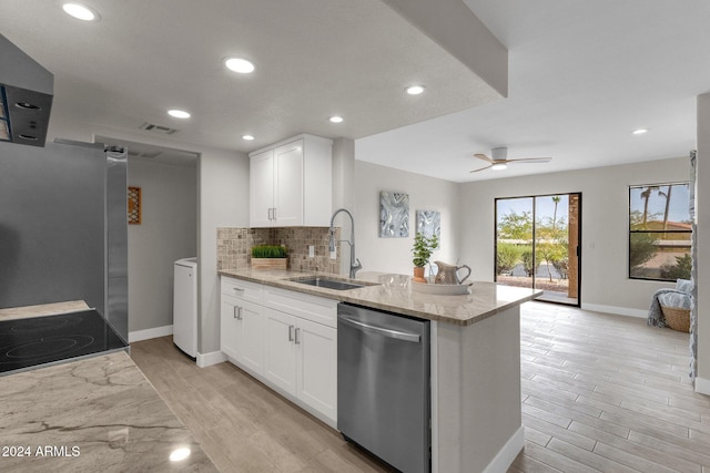 kitchen featuring sink, light stone counters, stainless steel dishwasher, decorative backsplash, and white cabinets