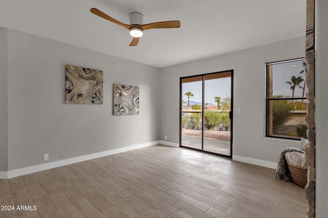 unfurnished room with ceiling fan and light hardwood / wood-style floors