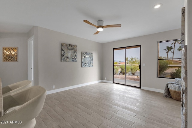 living room with ceiling fan and light wood-type flooring