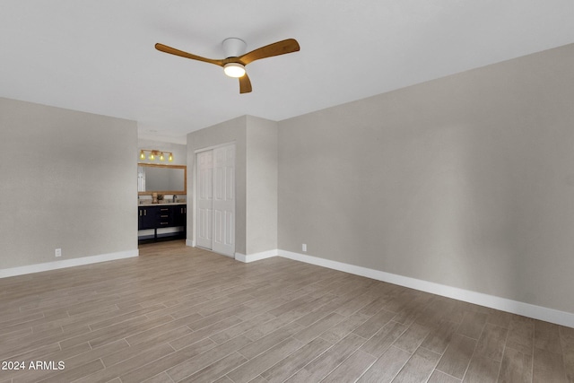 unfurnished living room featuring ceiling fan and light hardwood / wood-style floors