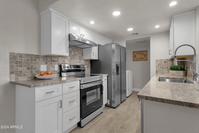 kitchen featuring white cabinetry, appliances with stainless steel finishes, sink, and light hardwood / wood-style floors