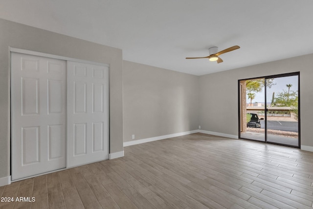 unfurnished bedroom with ceiling fan, light wood-type flooring, a closet, and access to outside