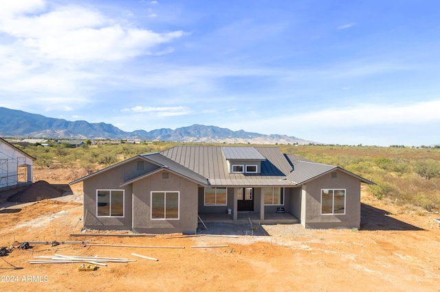 view of front facade featuring a patio and a mountain view