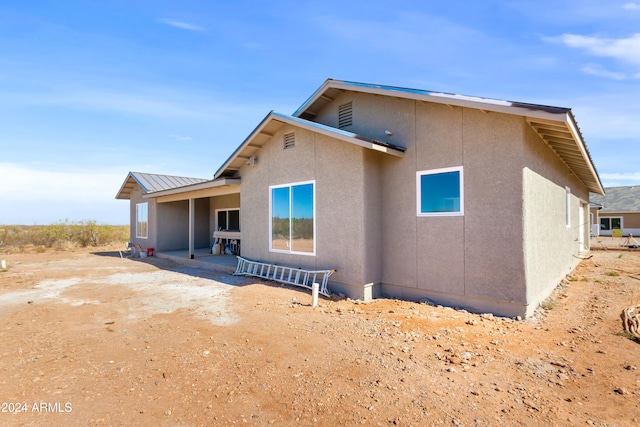 rear view of house featuring a patio