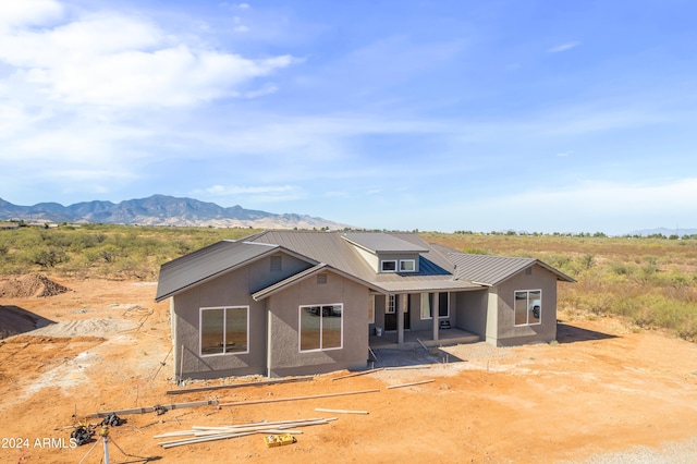 view of front facade with a mountain view and a patio area