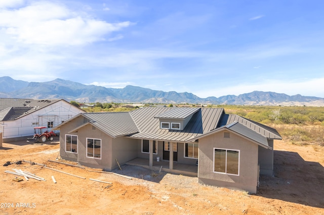 view of front of house with a mountain view and a patio
