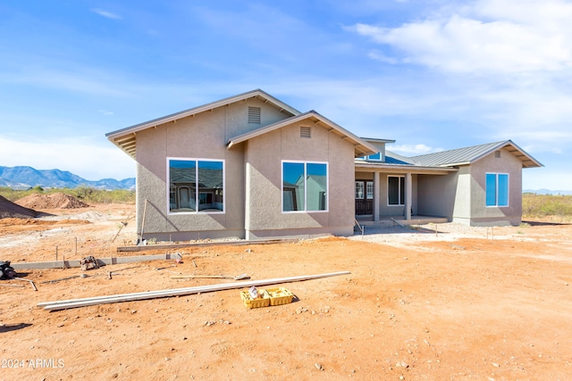 back of property with a mountain view