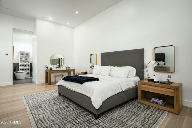 7614 E Cactus Wren Rd, Scottsdale, AZ 85250 - bedroom with baseboards, recessed lighting, light wood-style flooring, and a towering ceiling