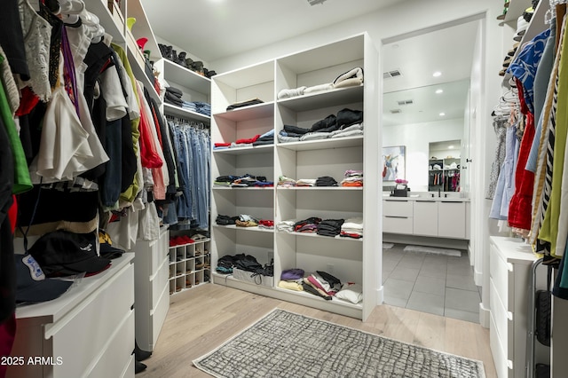 7614 E Cactus Wren Rd, Scottsdale, AZ 85250 - spacious closet featuring light wood finished floors, washer / clothes dryer, and visible vents