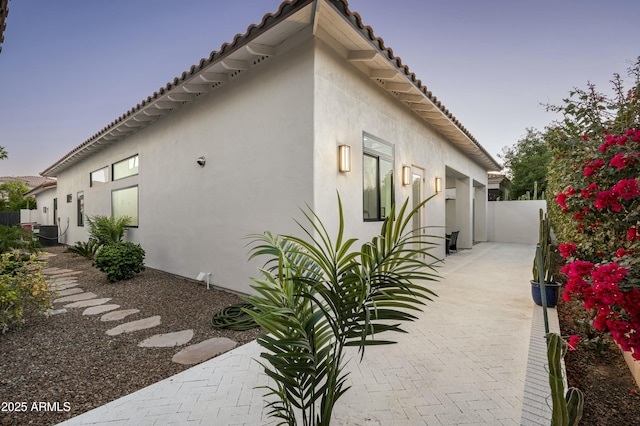 7614 E Cactus Wren Rd, Scottsdale, AZ 85250 - view of side of property with fence, a tile roof, and stucco siding