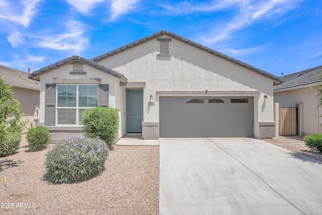 38150 W San Sisto Ave, Maricopa, AZ 85138 - view of front of home with an attached garage, driveway, and stucco siding