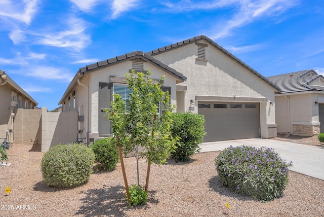 38150 W San Sisto Ave, Maricopa, AZ 85138 - view of front of house featuring stucco siding, an attached garage, concrete driveway, and fence