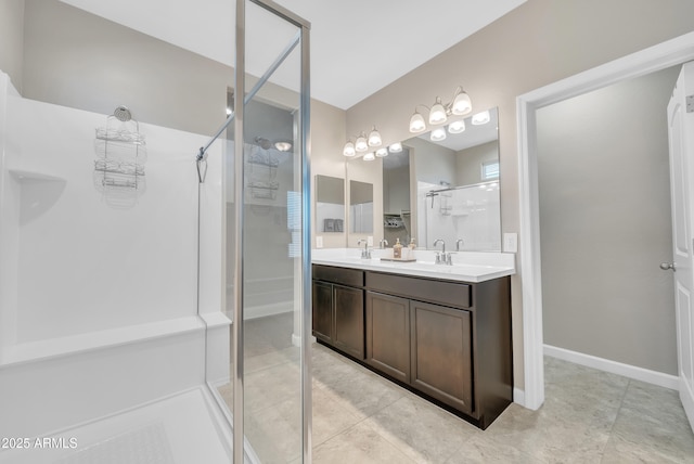 38150 W San Sisto Ave, Maricopa, AZ 85138 - bathroom featuring a shower stall, double vanity, tile patterned flooring, and baseboards